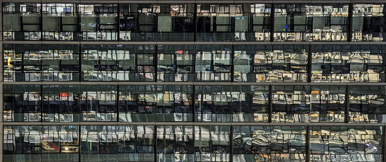A wide band of illuminated windows against a dark facade.