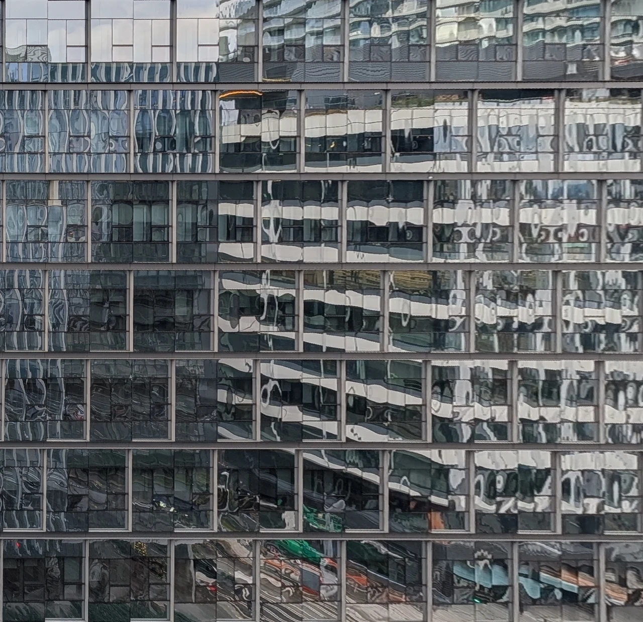 An intricate lattice of distorted reflections and steel frames.